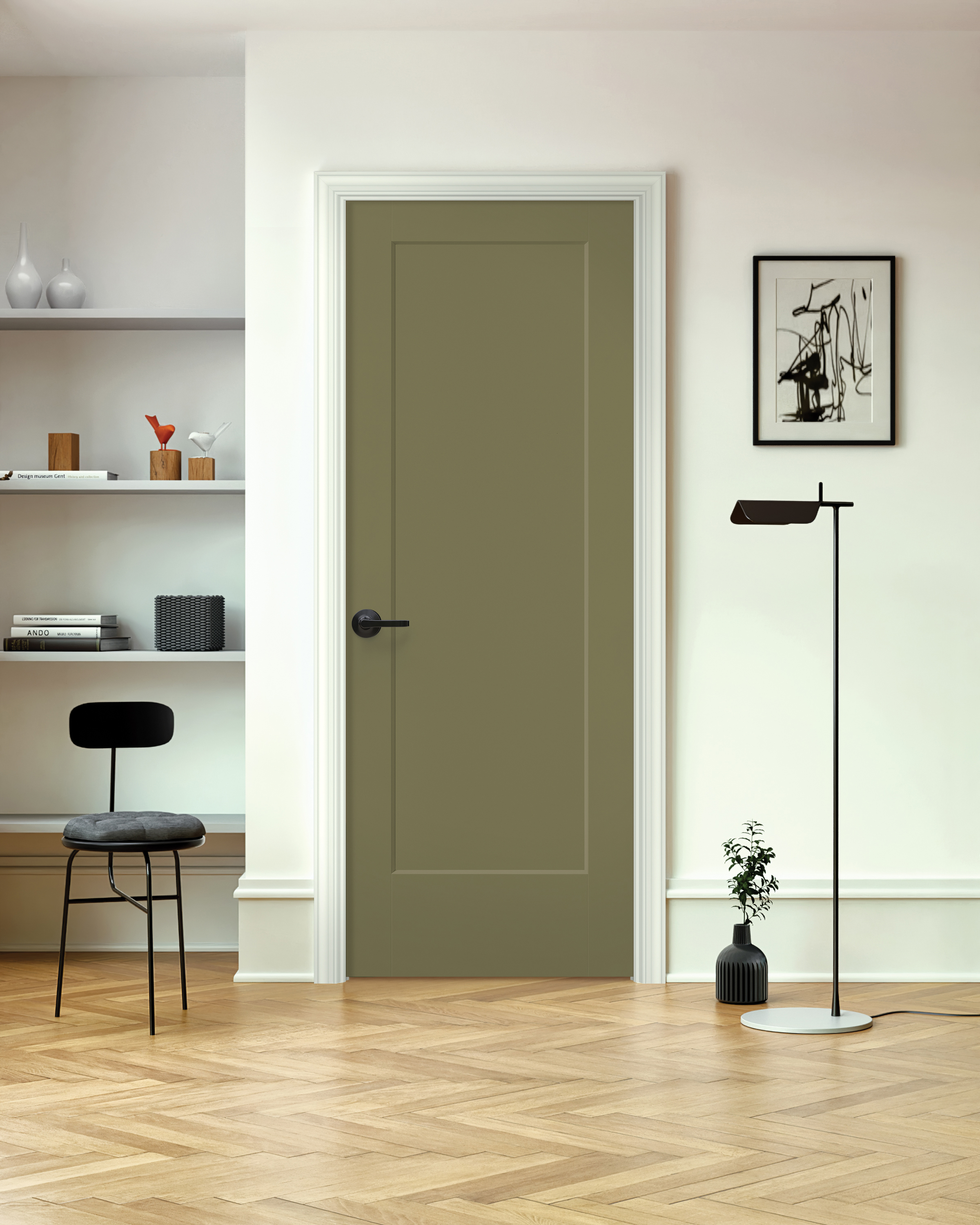 An olive green one-panel door set on a white wall with a desk to the left and a plant to the right
