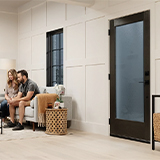 the interior of a living room with a 1 lite black exterior door